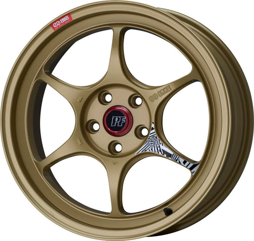 An Enkei PF06 18x7.5 gold alloy wheel with a 5x100 bolt pattern and a red Enkei logo in the center.