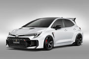 White Toyota GR Corolla with a front spoiler in carbon fiber on a gray background AImgain body kit