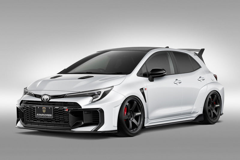 White Toyota GR Corolla with a front spoiler in carbon fiber on a gray background AImgain body kit