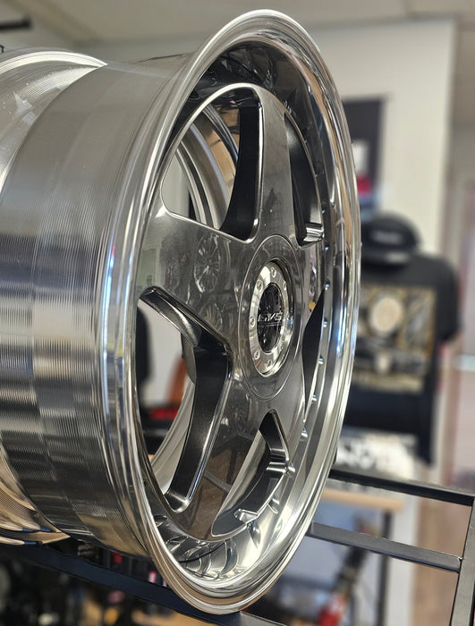 Close-up of a shiny metallic wheel rim with blurred background