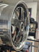 Close-up of a shiny metallic wheel rim with blurred background