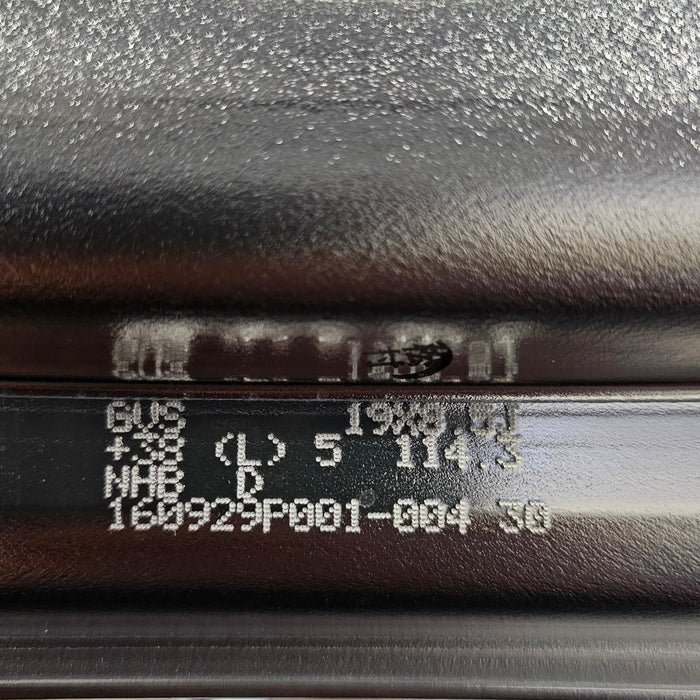 Close-up of a bicycle rim with text and numbers on a blurred background