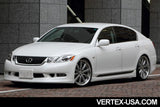 White Lexus with vertex body kit parked in front of a gray building