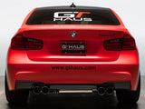 Meisterschaft license frame and GTHAUS license plate on a red BMW, showcasing premium performance branding.