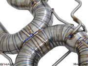 Close-up of hand-welded stainless steel exhaust piping for BMW E90/92/93 M3, showcasing precision craftsmanship and quality.