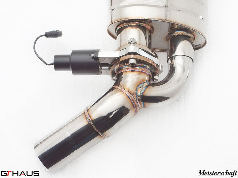 Close-up of a polished stainless steel exhaust system with electronic valve control for Mercedes-Benz W221 S63 AMG.