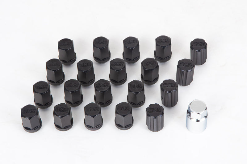 Set of black tire valve stems with a silver tool on a white background