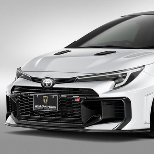 White GR Corolla car with a black grille and front bumper Aimgain carbon fiberbody kit on a gray background pmddriven pmd vip website