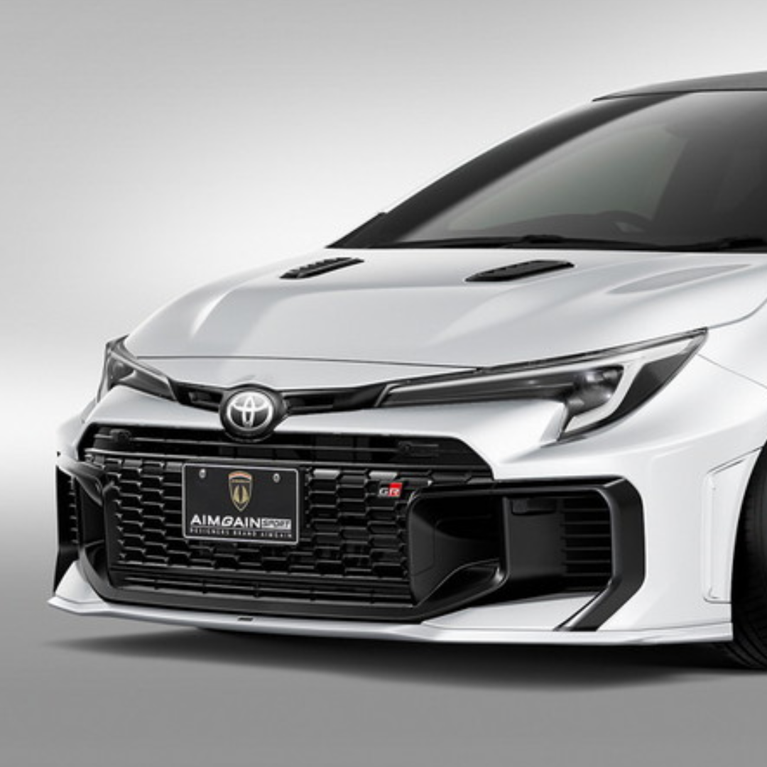 White GR Corolla car with a black grille and front bumper Aimgain body kit on a gray background pmddriven pmd vip website