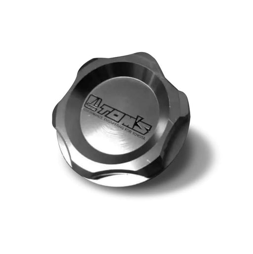 Metallic oil cap with 'Lukas' branding on a white background