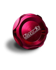 Red metal oil cap with Toms branding on a white background