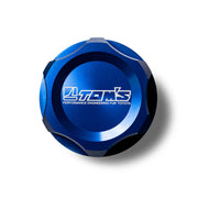 Blue metal cap with 'TOM'S' branding on a white background