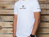 White MEISTERSCHAFT T-shirt featuring the logo, styled for Audi R8 enthusiasts, displayed against a wooden backdrop.